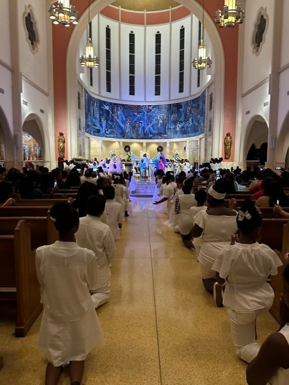 A group of people are sitting in a church watching a concert.