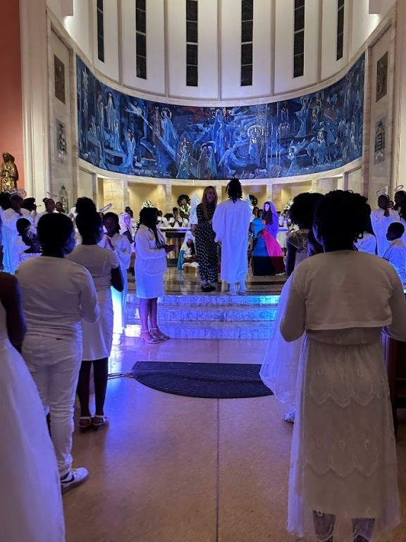 A group of people in white standing in a church