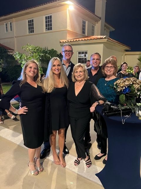 A group of people posing for a picture in front of a building