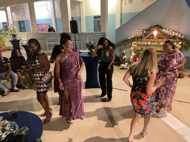 A group of women are dancing in a room at a party.