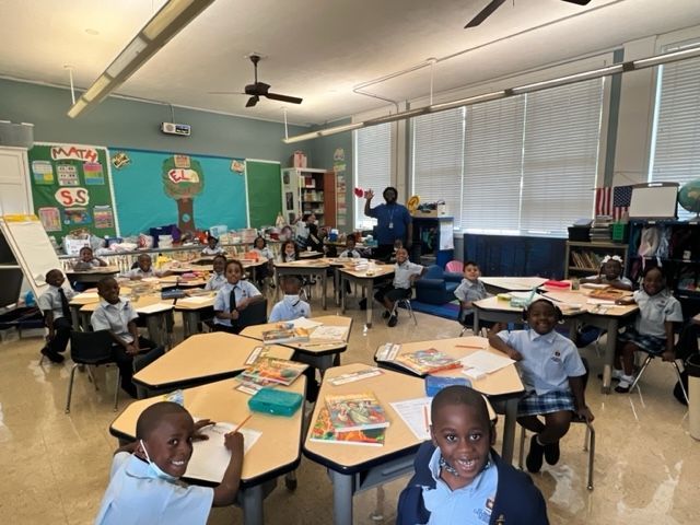 A group of children are sitting at their desks in a classroom