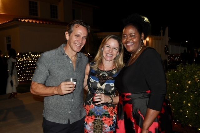A man and two women are posing for a picture together