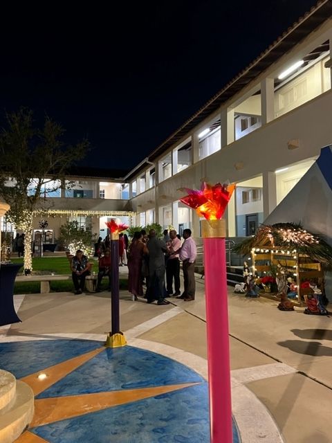 A group of people are standing in front of a building at night.