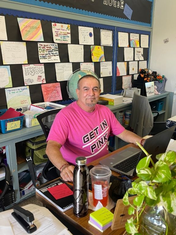 A man wearing a pink shirt that says get in pink