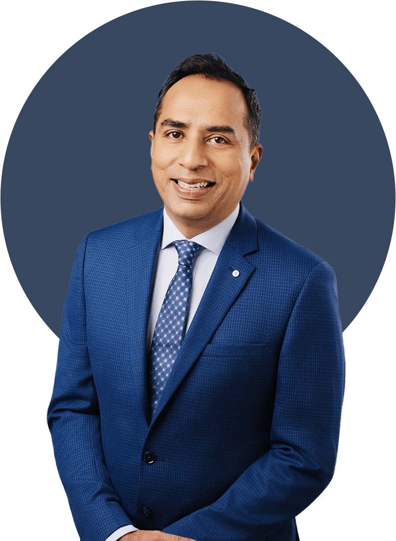 Man in blue suit, smiling, set against a dark blue circle.