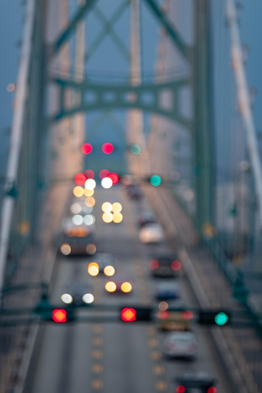Bridge with traffic; red and green traffic lights; blurred lights.