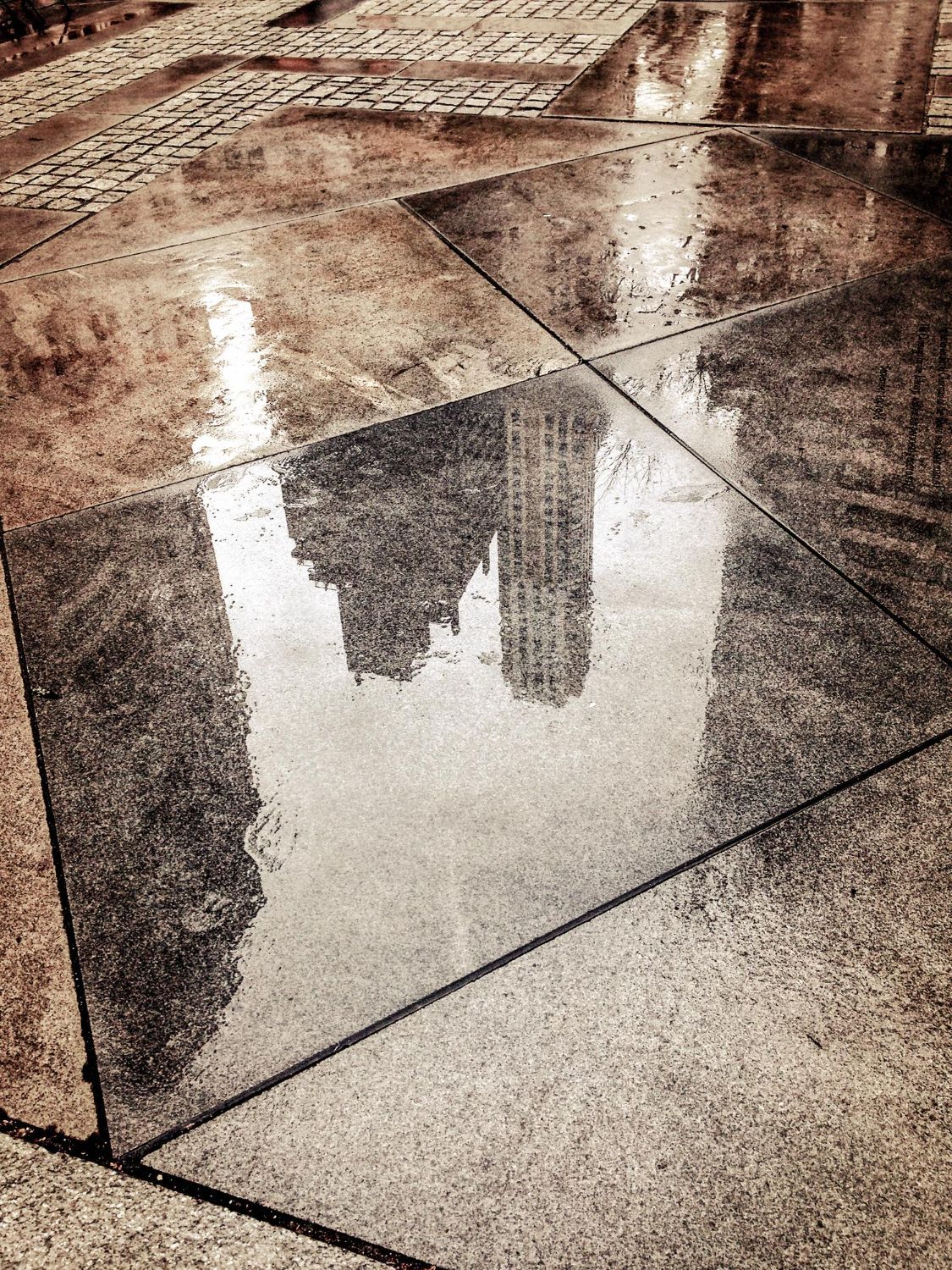 Reflections on a wet marble floor in a Boca Raton retail corridor.