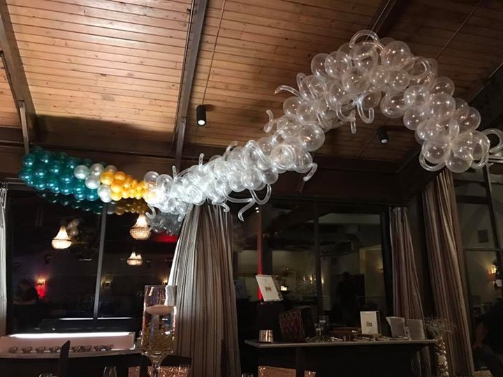 A fun and beautiful garland made of various balloon shapes and colors floats near the ceiling.