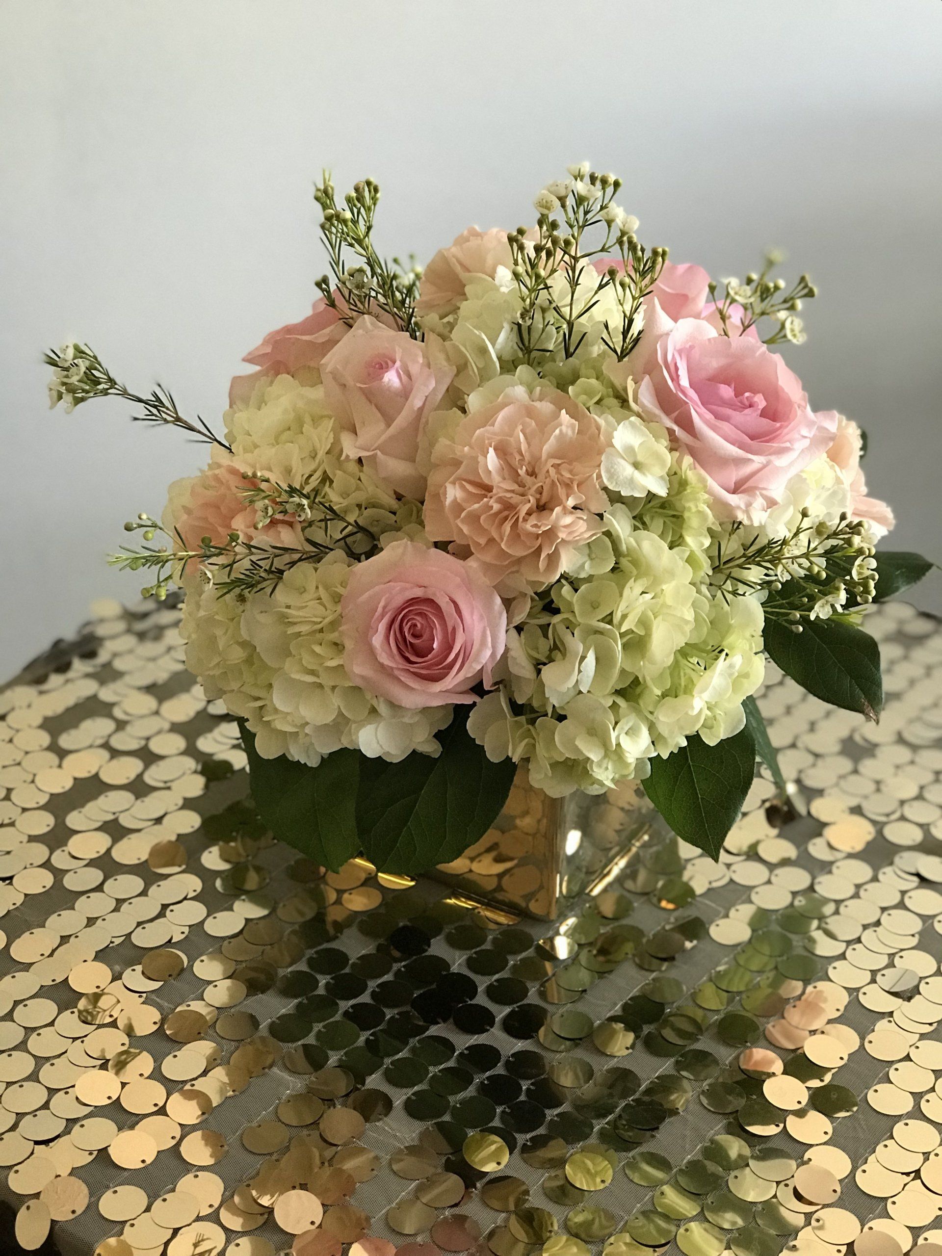 Beautiful floral centerpiece in a square vase.