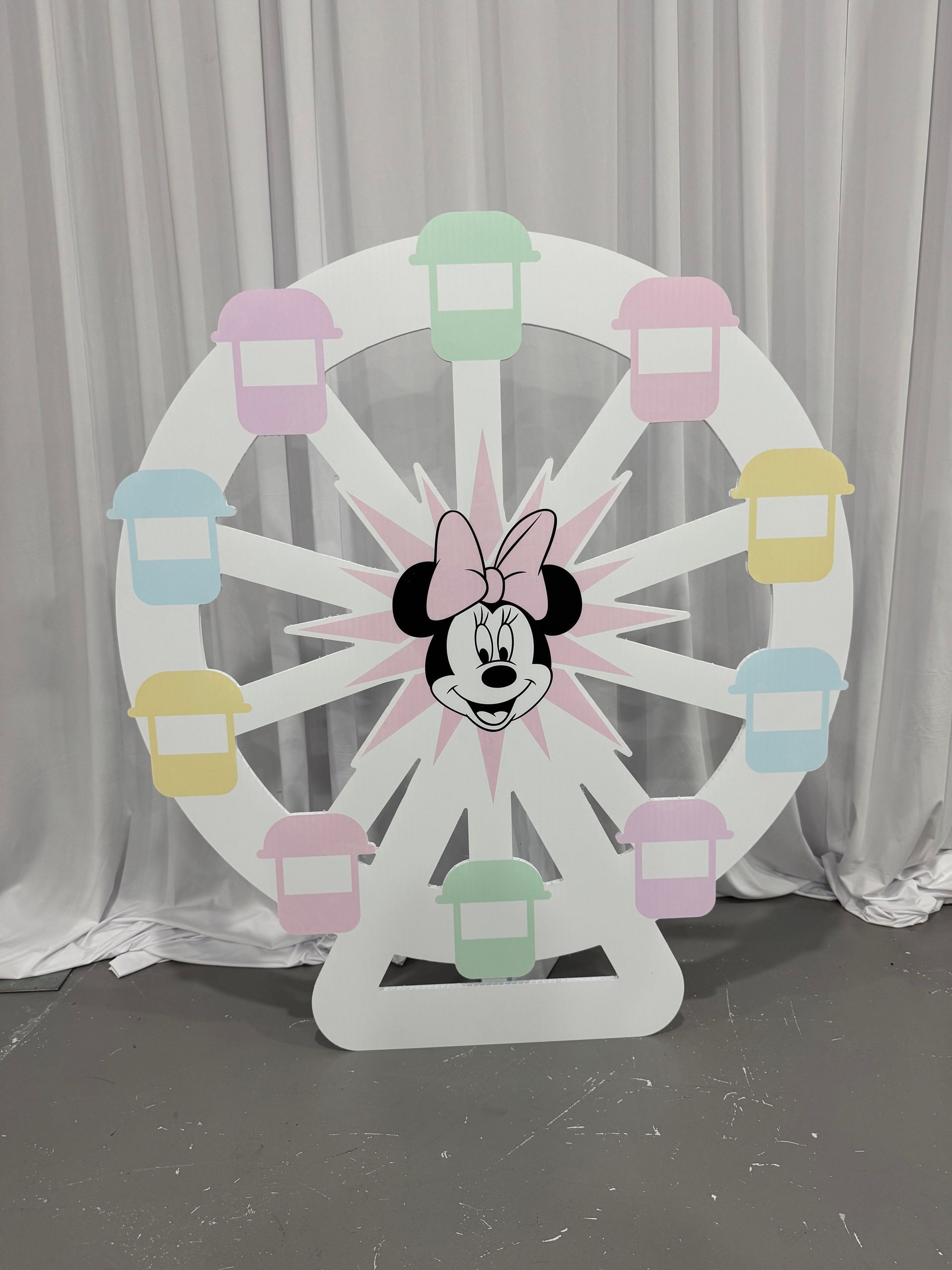 Pastel ferris wheel prop backdrop with soft colors and draping for whimsical kids party photo area