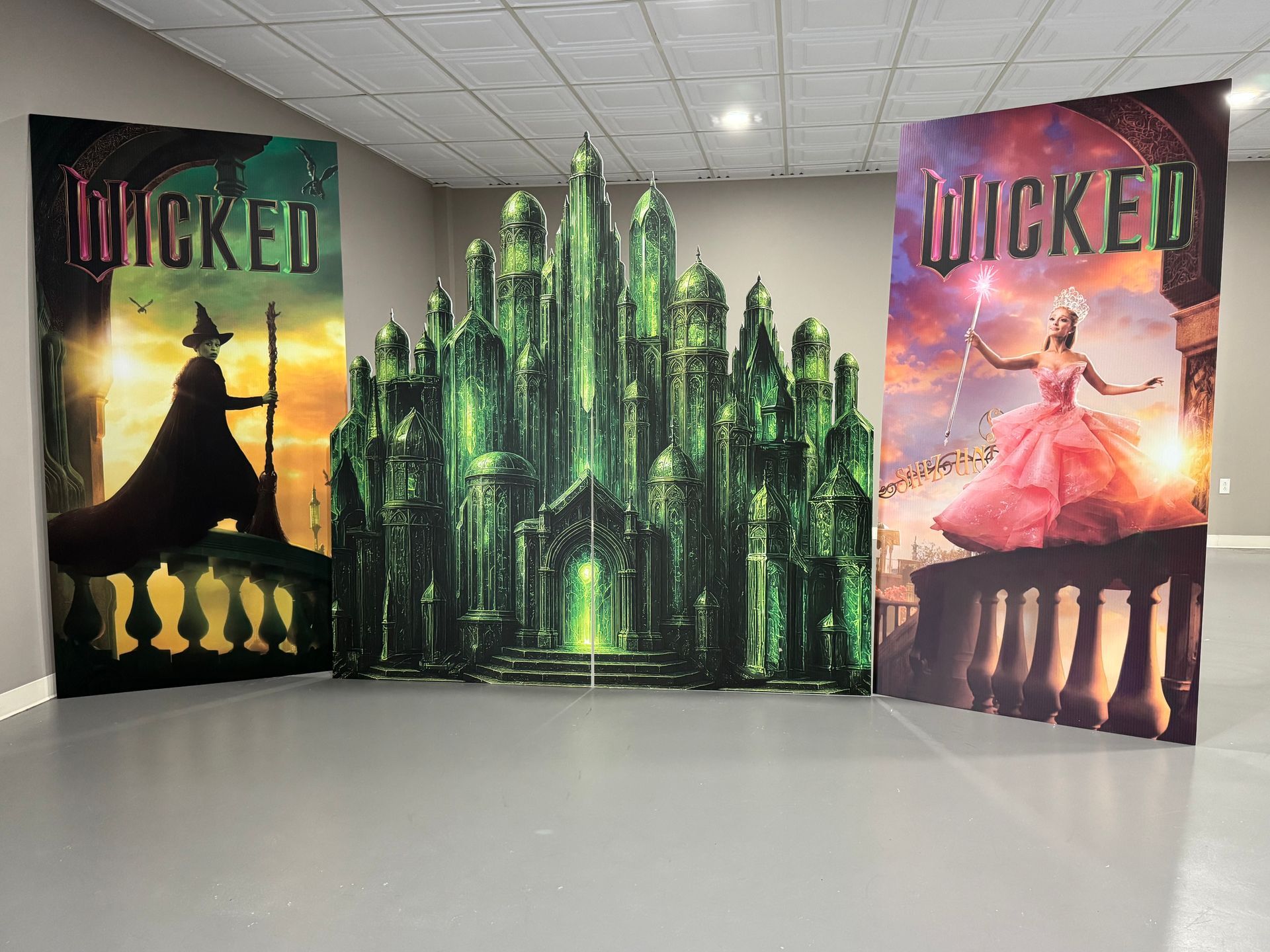 Wicked movie themed backdrop panels with Emerald City graphics for dramatic kids or teen party setup
