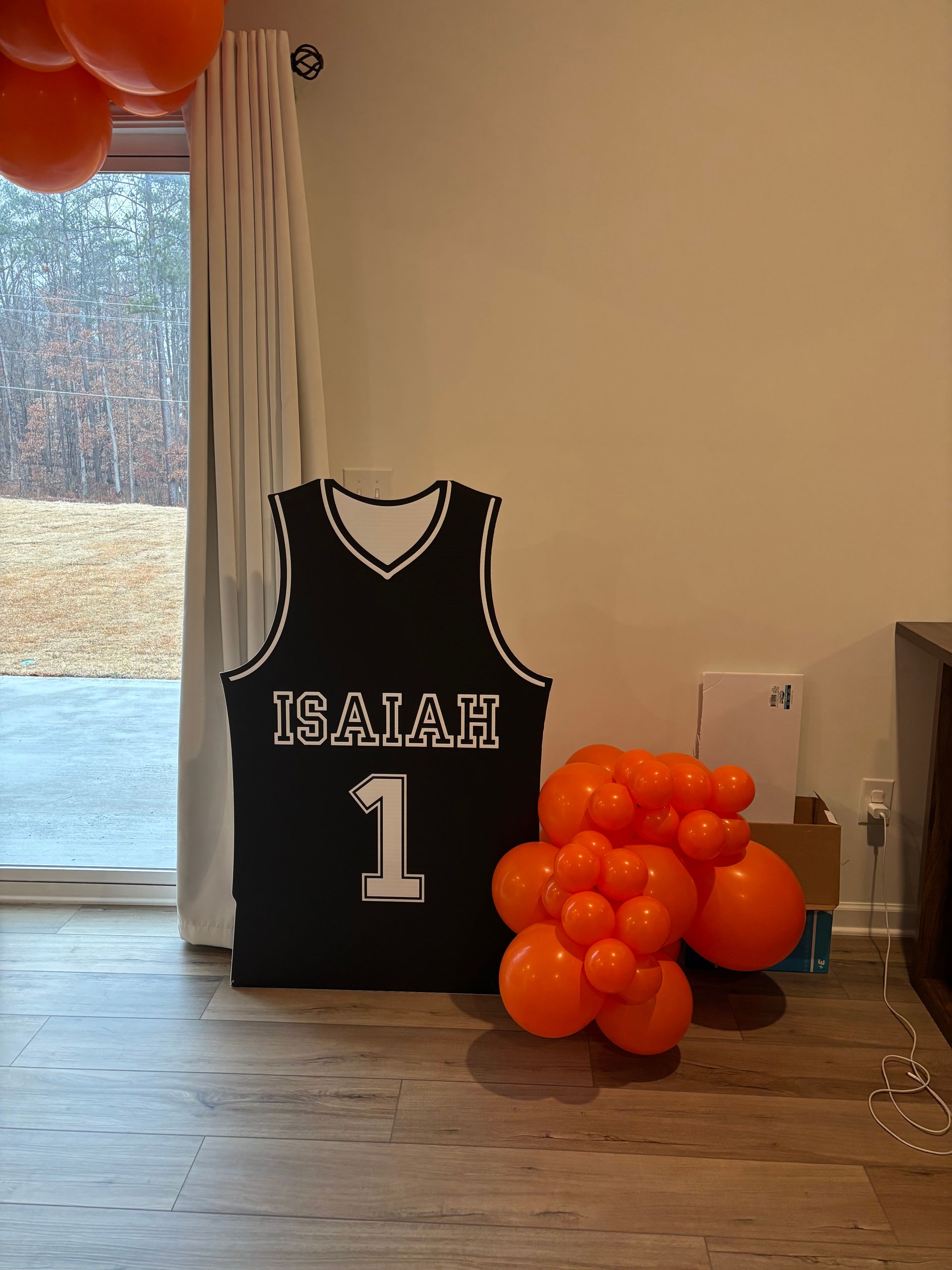 Indoor kids party space with simple backdrop and window lighting for custom themed event setup