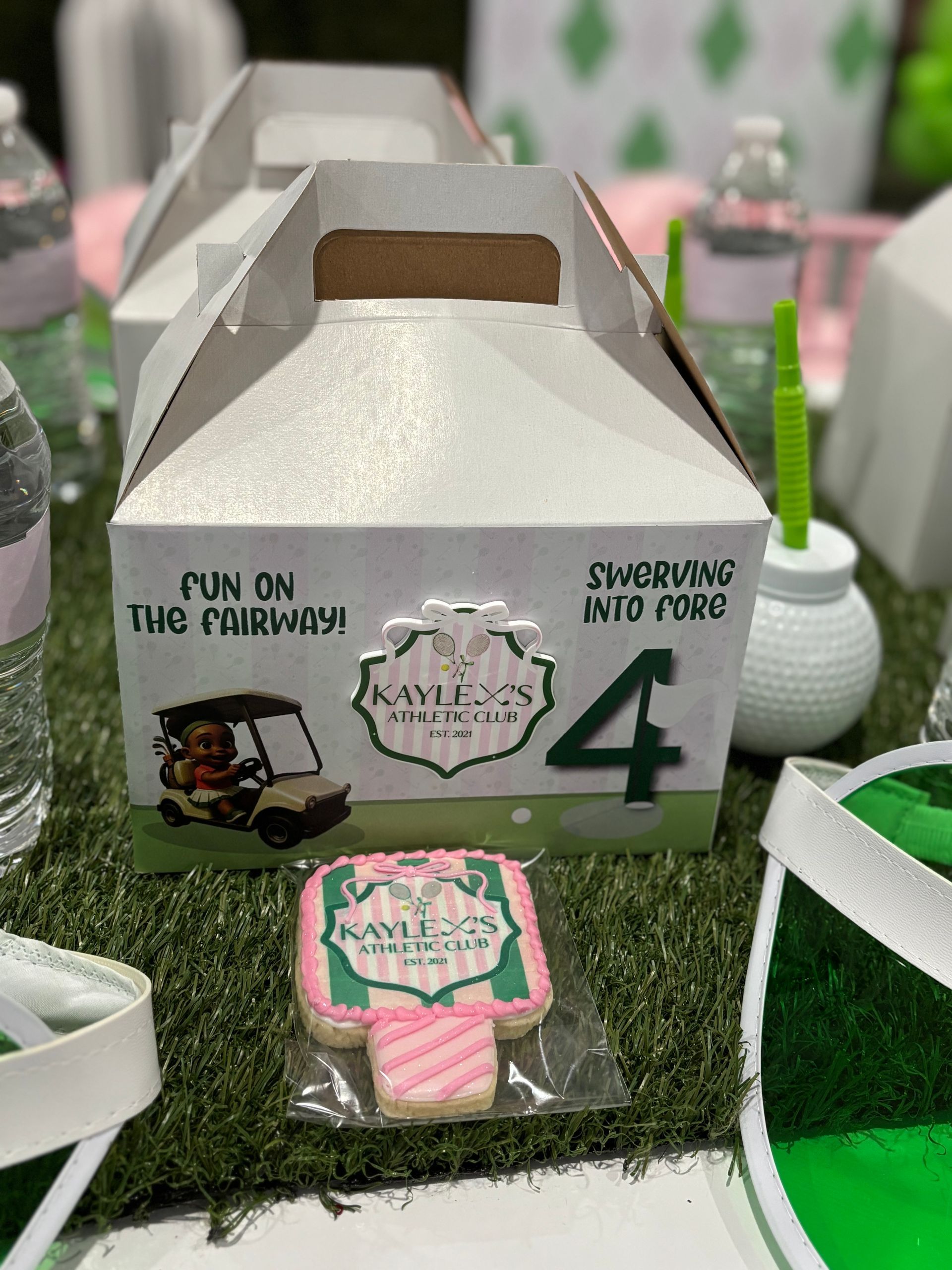 White party favor boxes arranged on kids event table for birthday treats and take-home gifts