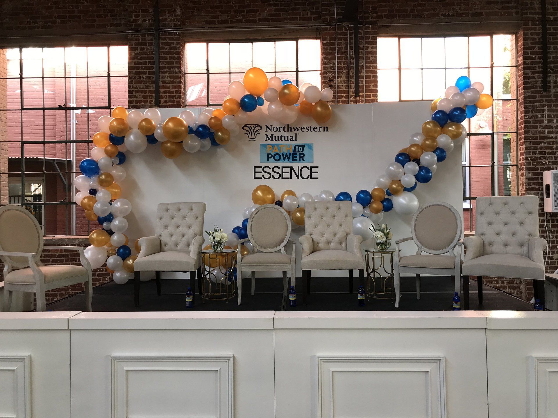 Balloon garlands make an otherwise boring backdrop pop with color.
