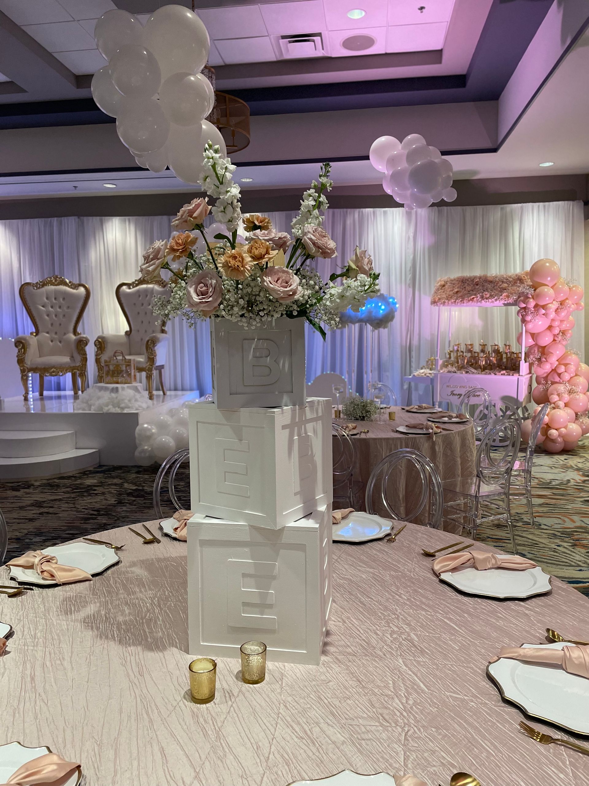 A beautiful candle display with various sizes of holders and types with white candles.