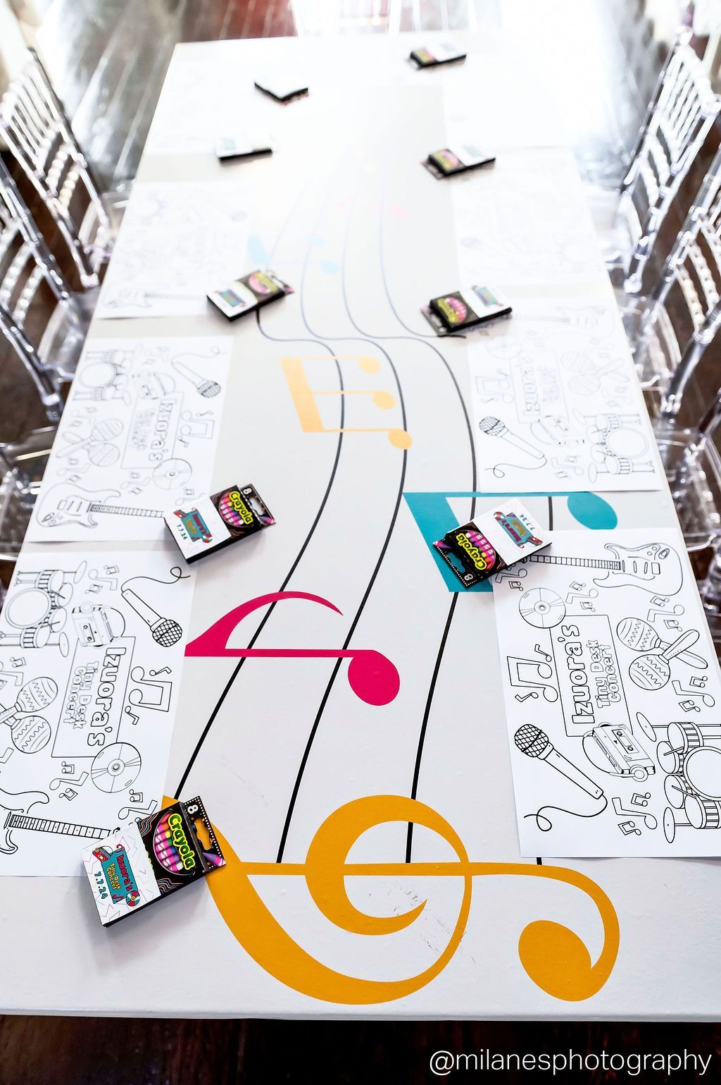 Kids activity table setup with paper covers and crayons for children’s event