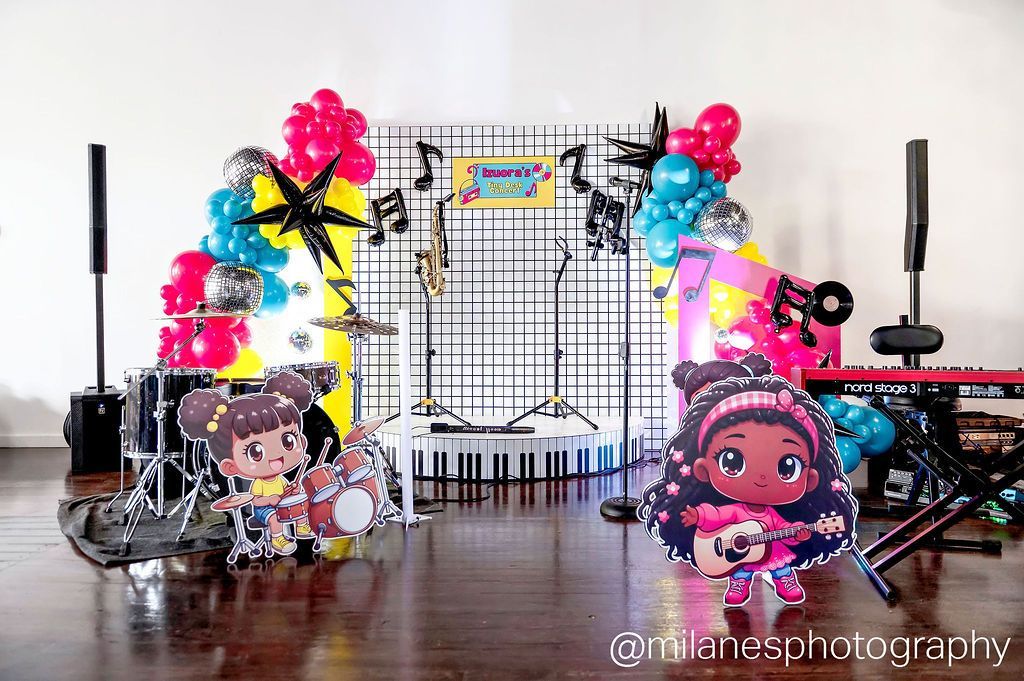 Custom kids party backdrop with bright balloons, character cutouts, and stage setup