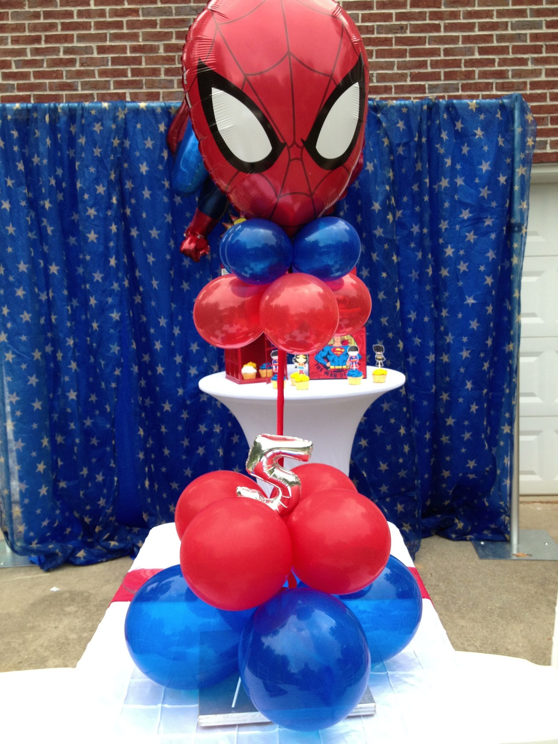 A Spiderman themed column comprised of balloons with a small number 5.