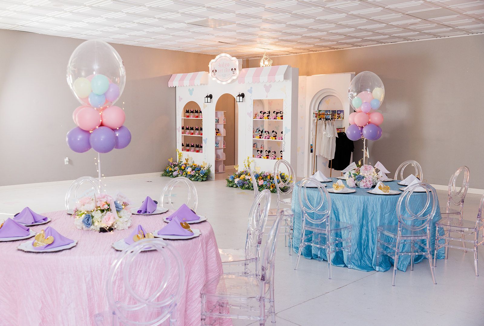 Princess themed kids party tables with pastel linens, balloon clusters, and elegant tea party place settings
