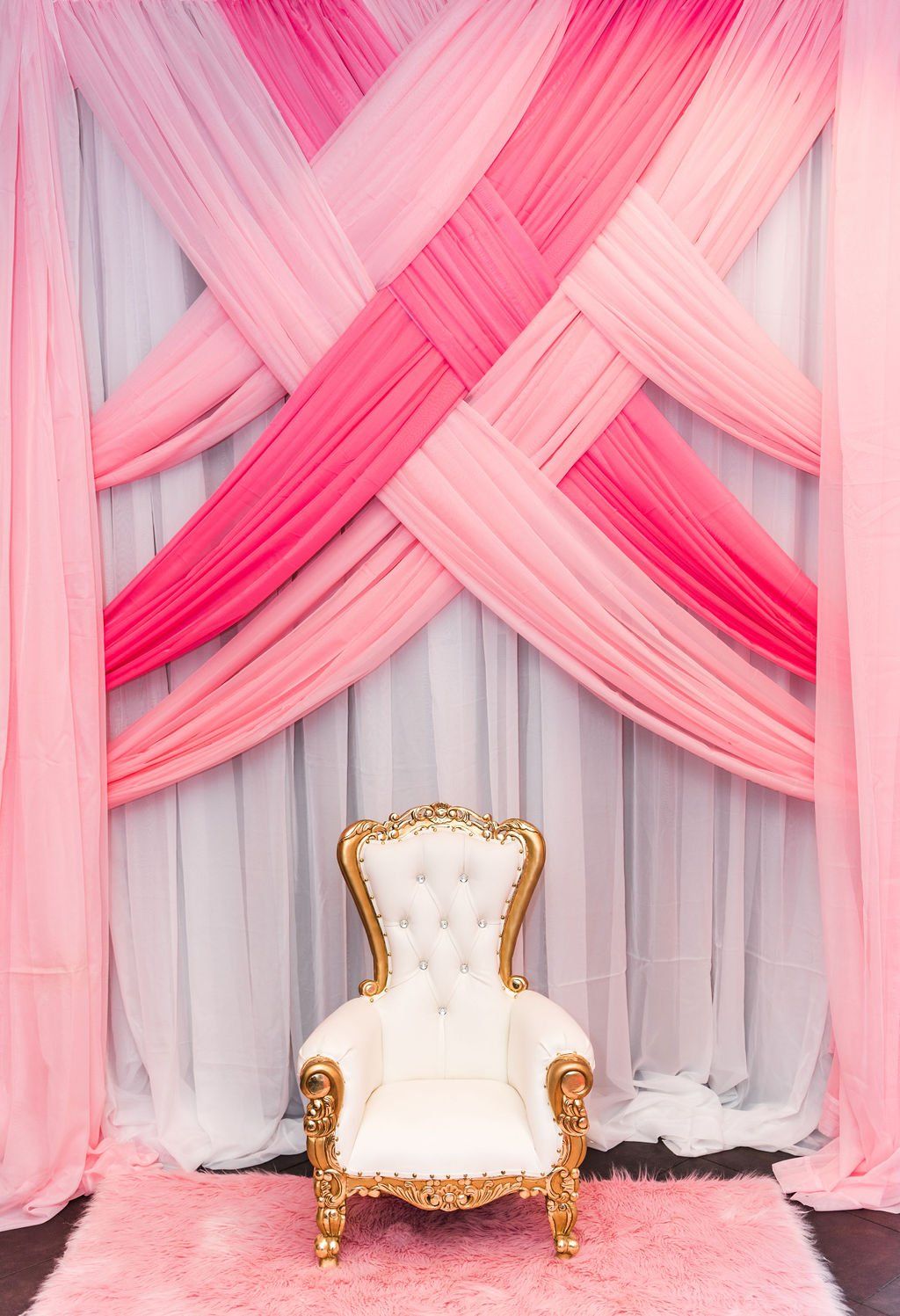 A kids throne with draping in the background for a custom theme.