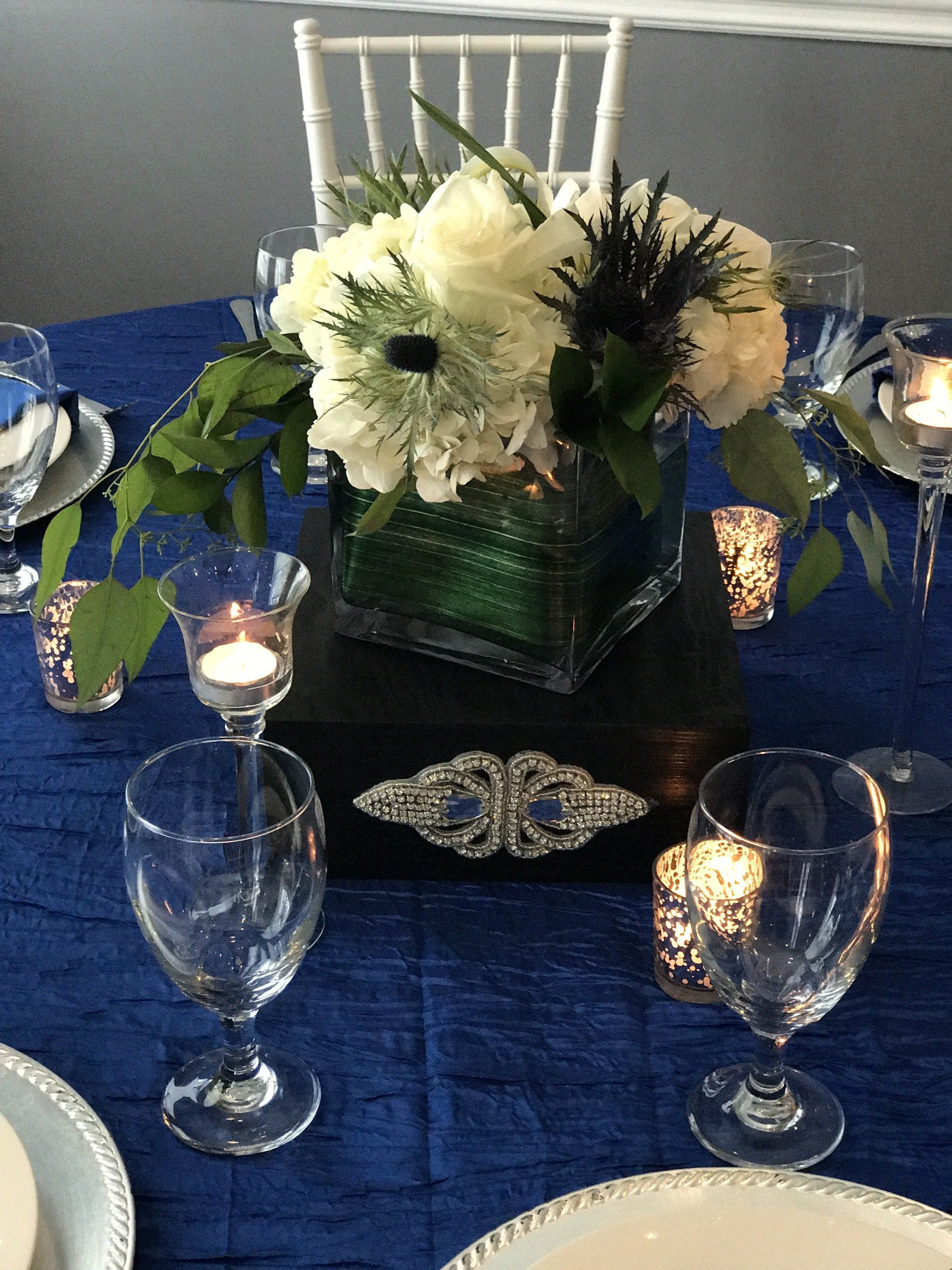Custom designed multi level centerpiece (floral arrangement in a glass square vase sitting on a beautiful box with an embellishment
