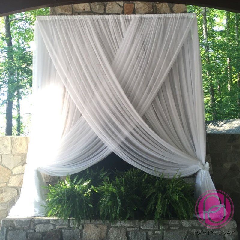 ceremony draping for a backdrop at a wedding with a crisscross design.