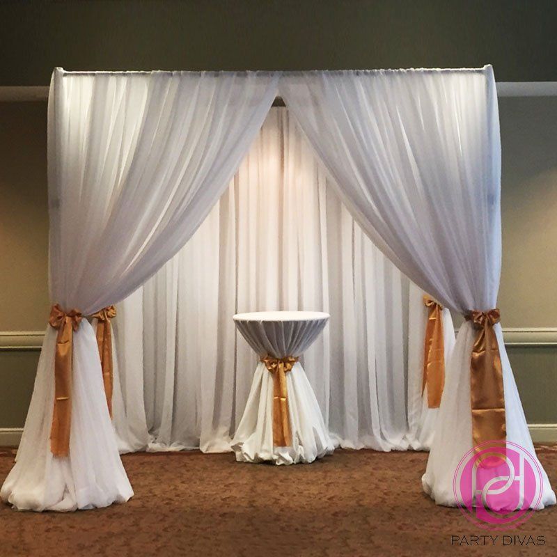A fabric draped ceremony canopy (Chuppah) setup inside.