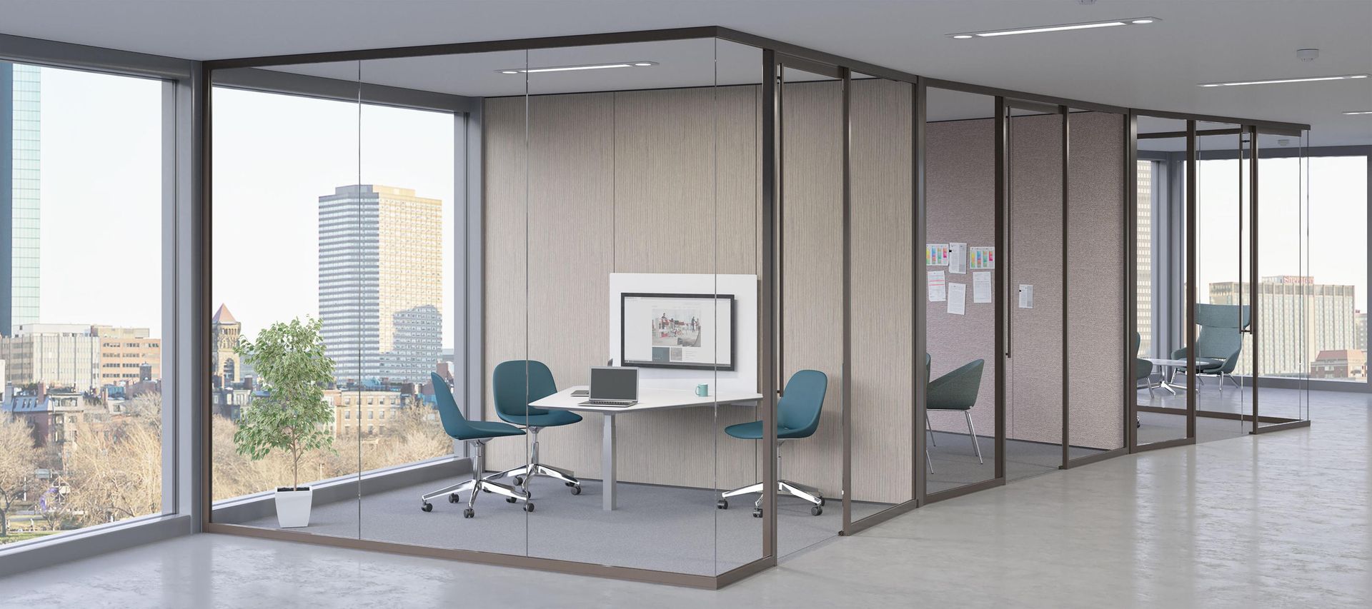 Modern office interior with glass-walled meeting rooms. Views of city buildings through large windows. Furnishings include tables and chairs.