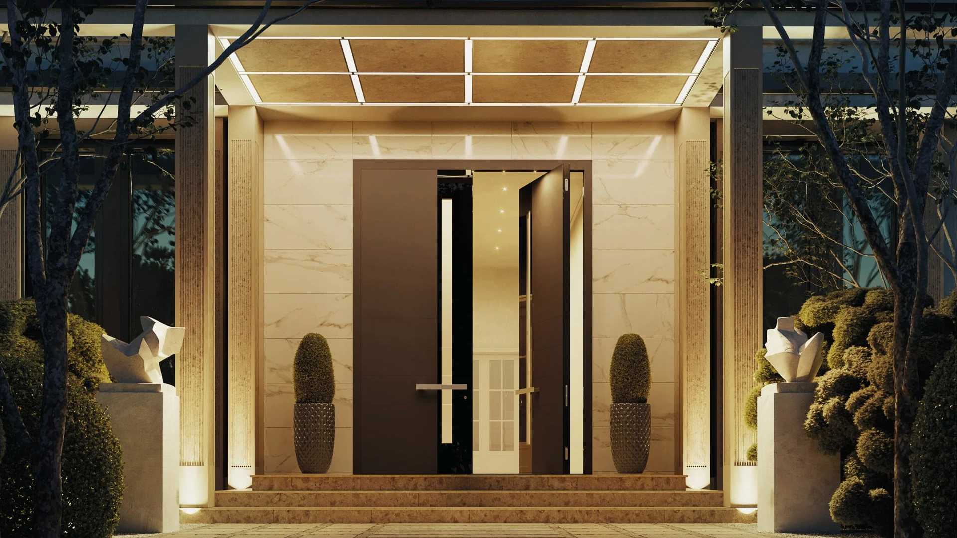 An illuminated modern entryway with a partially open dark door. Two large pillars flank the entrance. Two potted plants, along with statues, are visible.