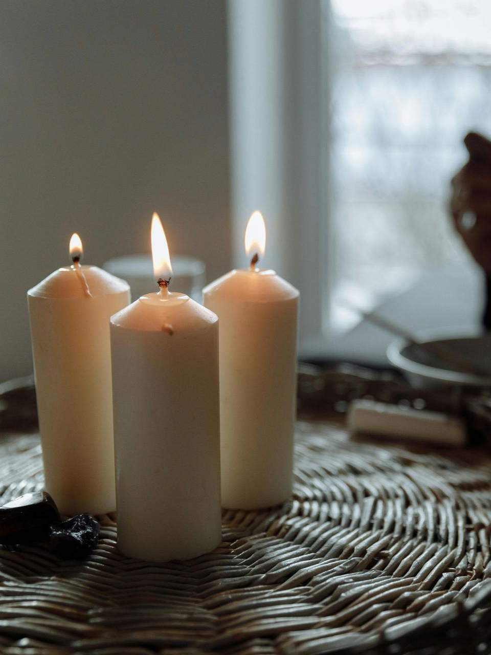 Three lit candles at Enlightened Life Temple in Denver, CO