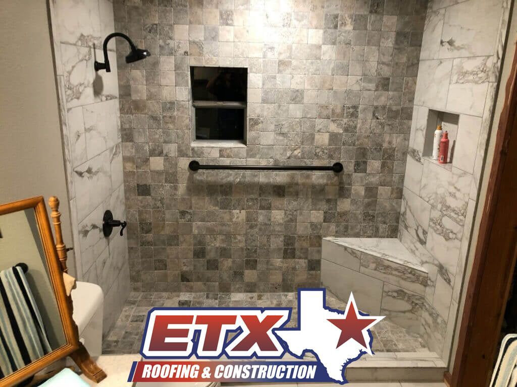 A bathroom with a walk in shower and a mirror.