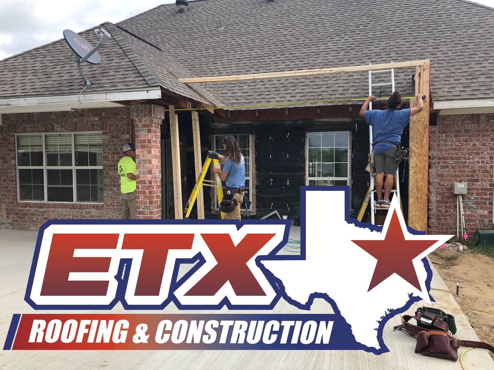 A sign for etx roofing and construction is in front of a house