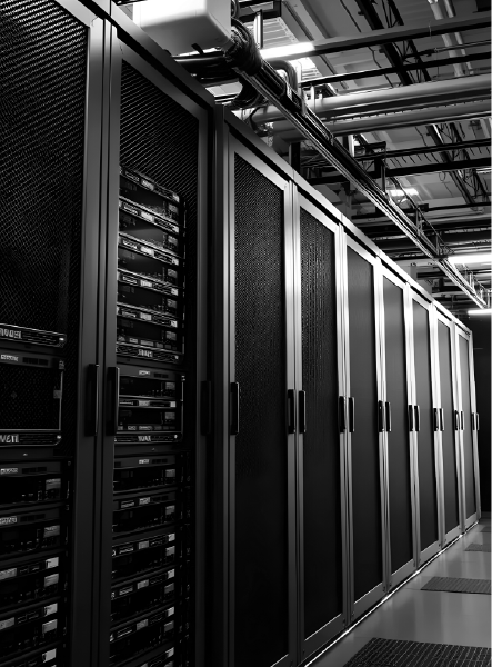 Server racks in a data center hallway, with black doors and equipment visible.