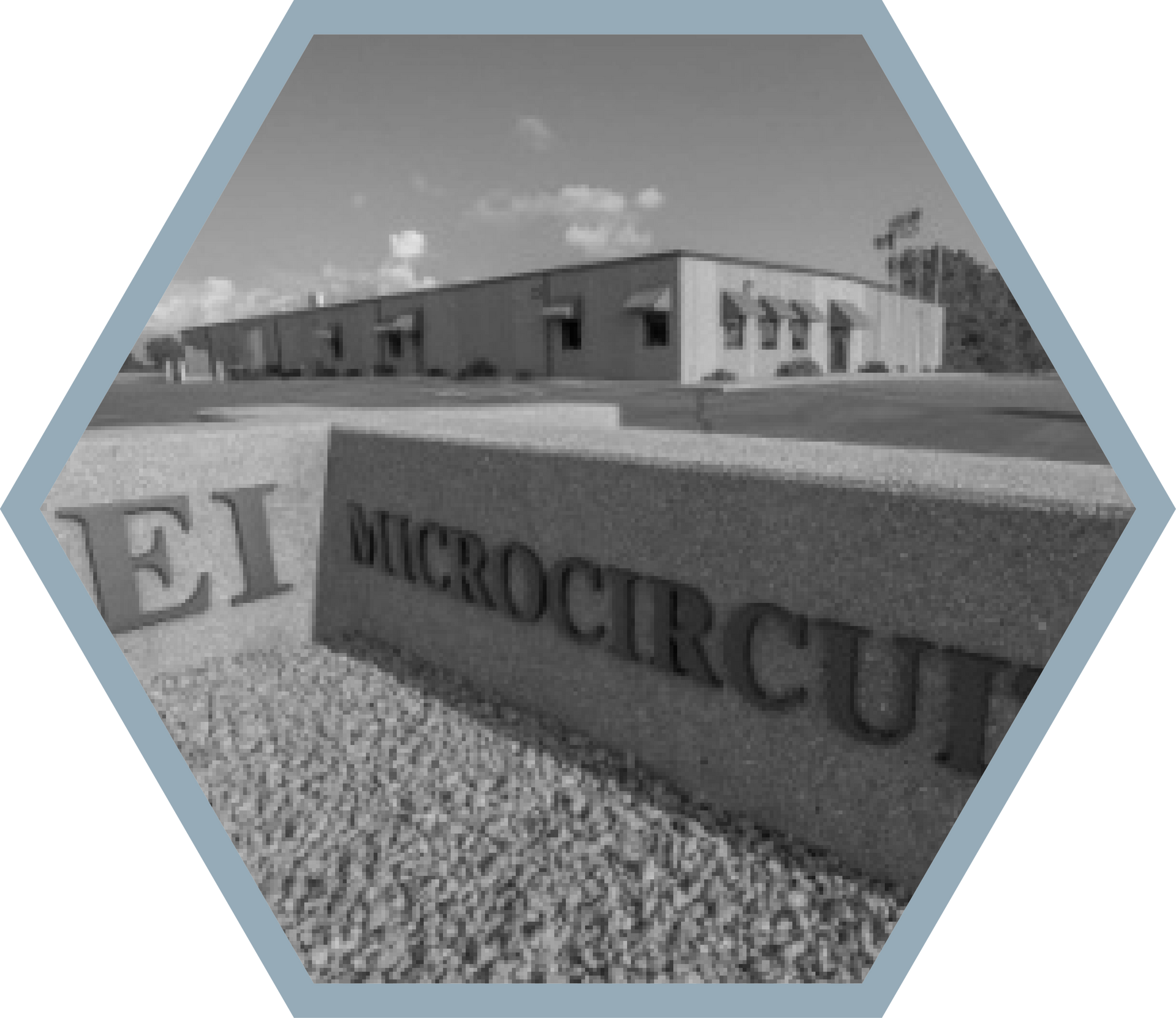 EI Microcircuits building and sign in grayscale.