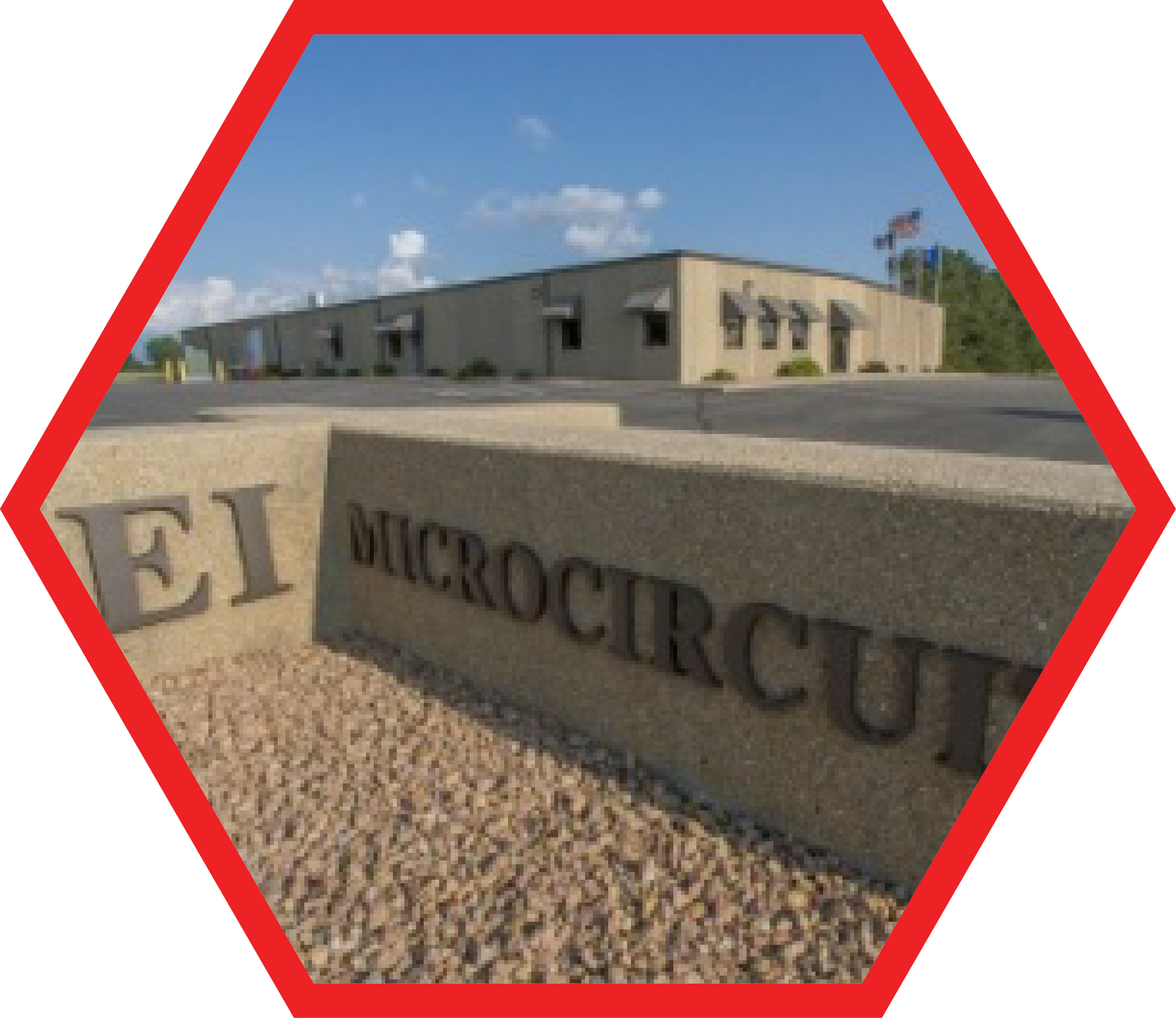 EI Microcircuits building with a sign in front.