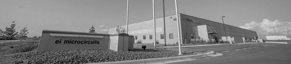 Black and white photo of a building with a sign that says