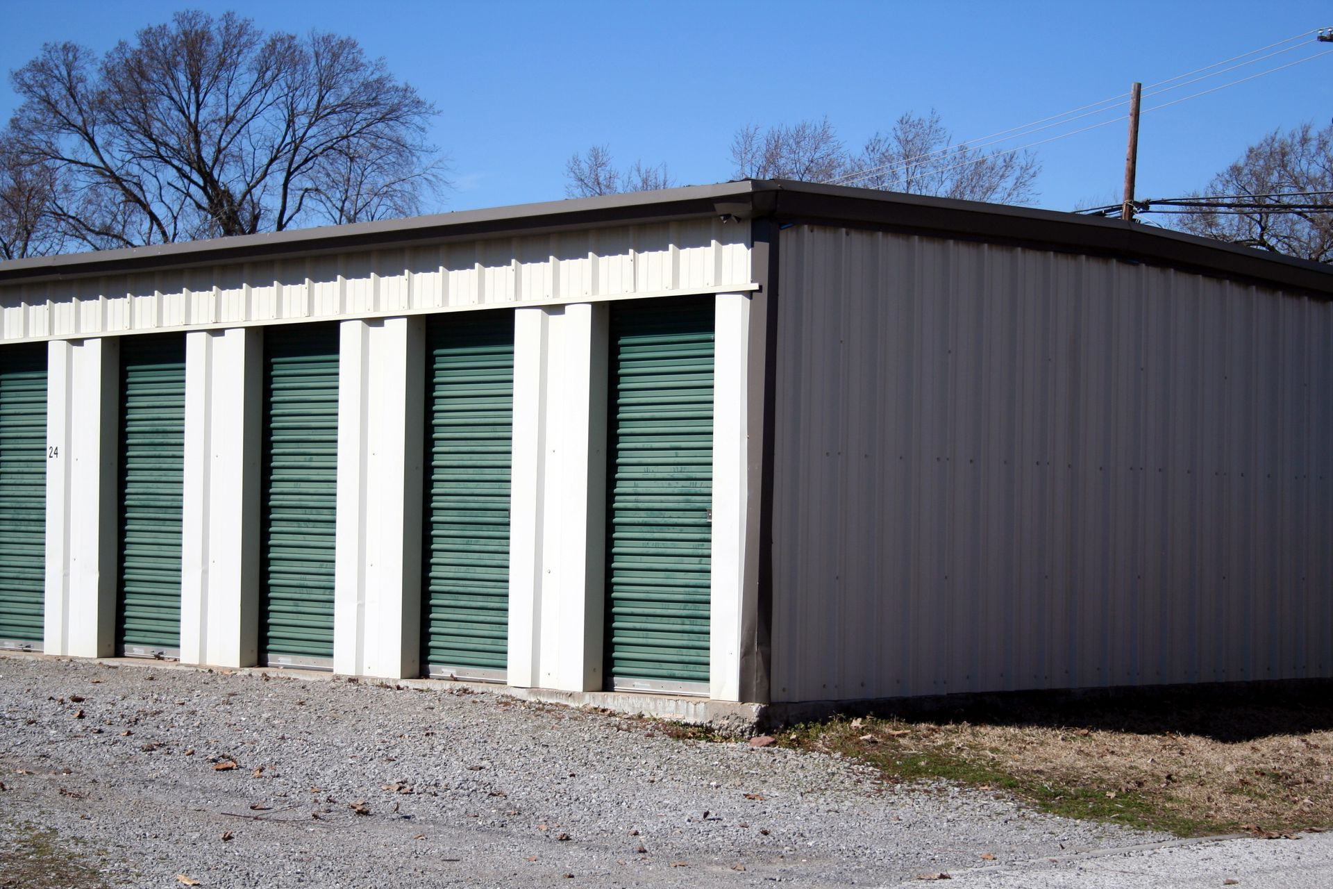 A row of storage units with green doors