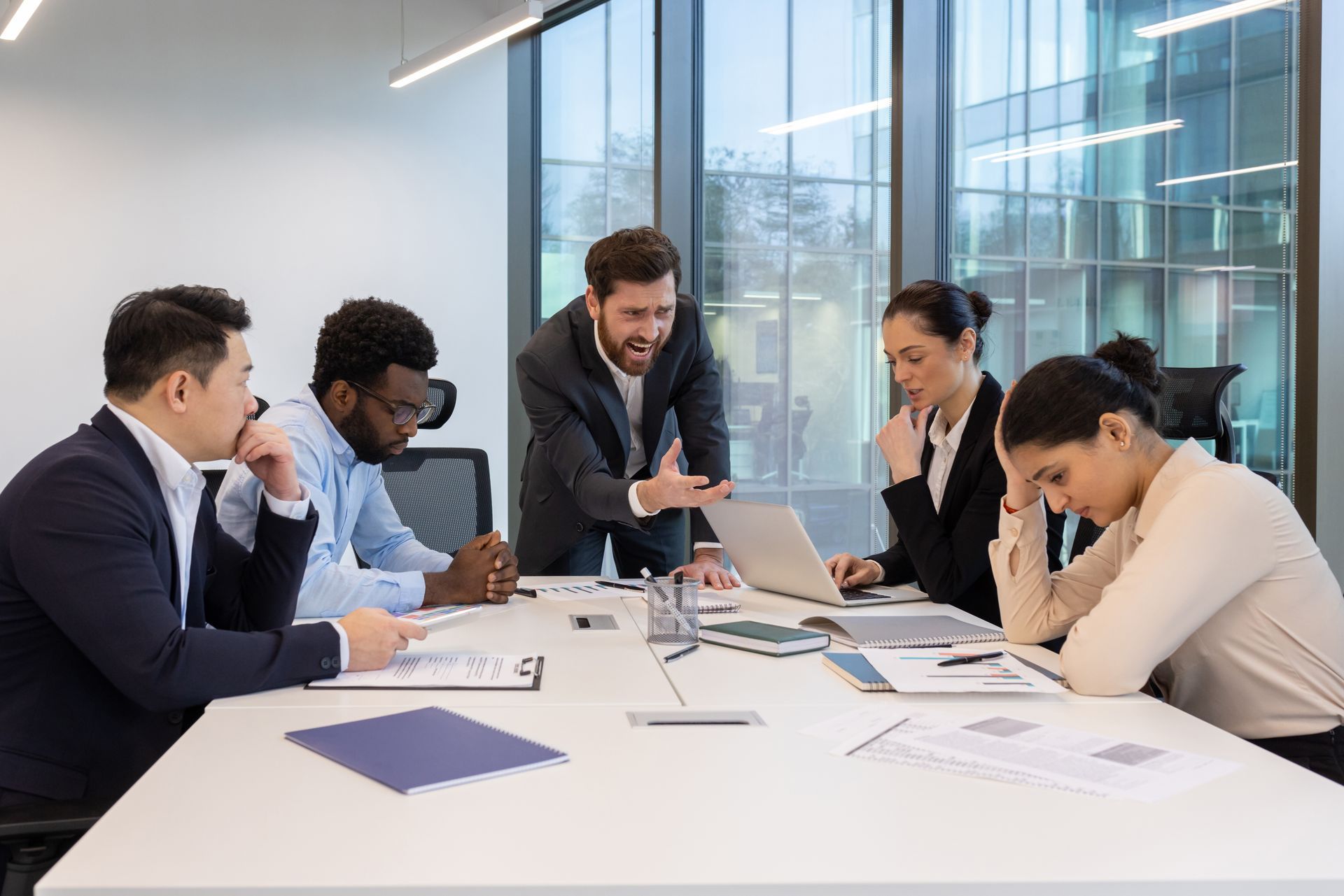 Business team in a meeting with an angry boss.