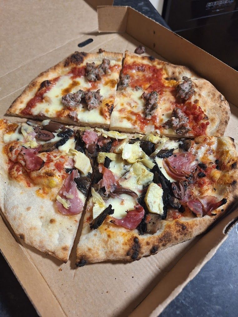 A Pizza With A Lot Of Toppings Is In A Cardboard Box — Mumbo's Pizza'n'Pasta In Lismore, NSW