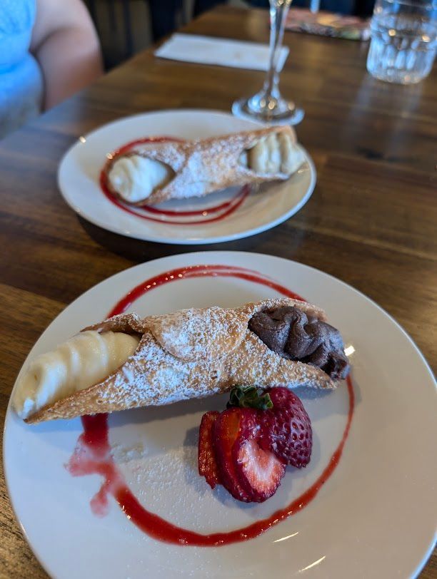A White Plate Topped With A Cannoli And Strawberries — Mumbo's Pizza'n'Pasta In Lismore, NSW