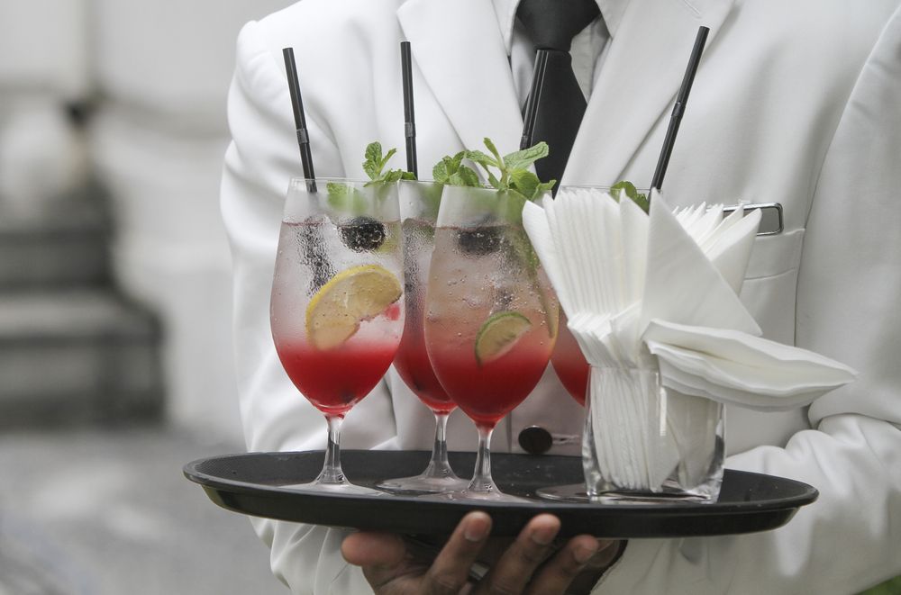 A Waiter is Holding a Tray With Three Drinks on It — Mumbo's Pizza'n'Pasta In Lismore, NSW