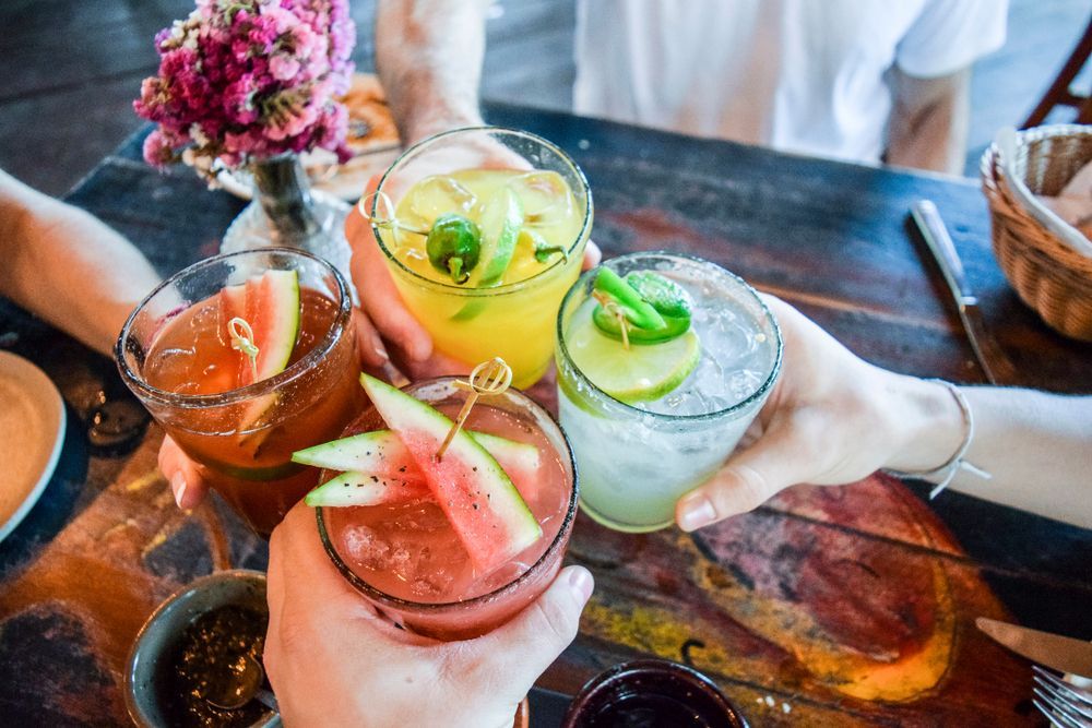 A Group of People Are Toasting With Drinks at a Table — Mumbo's Pizza'n'Pasta In Lismore, NSW