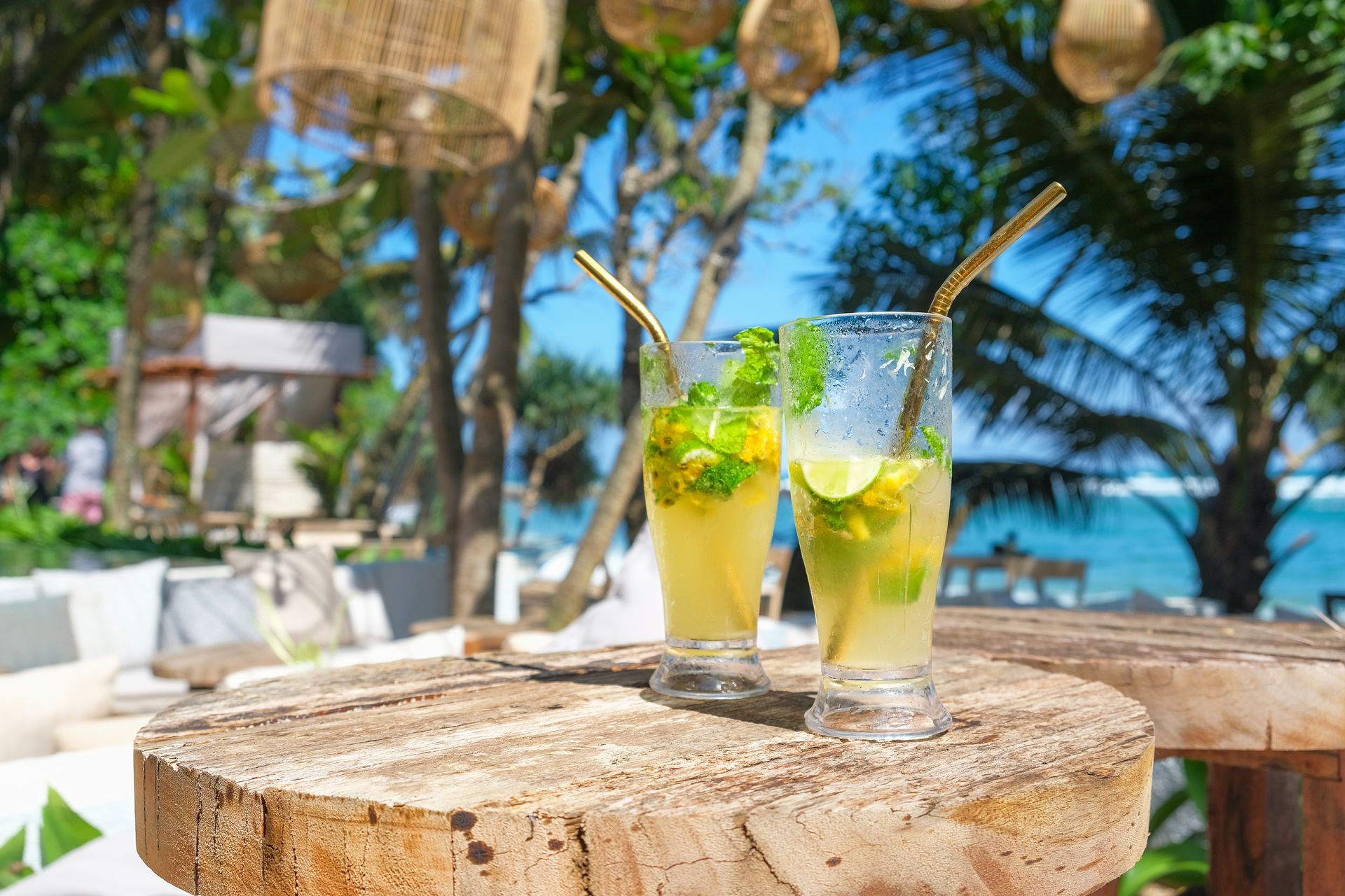 Two Drinks With Straws Are Sitting on a Wooden Table — Mumbo's Pizza'n'Pasta In Lismore, NSW