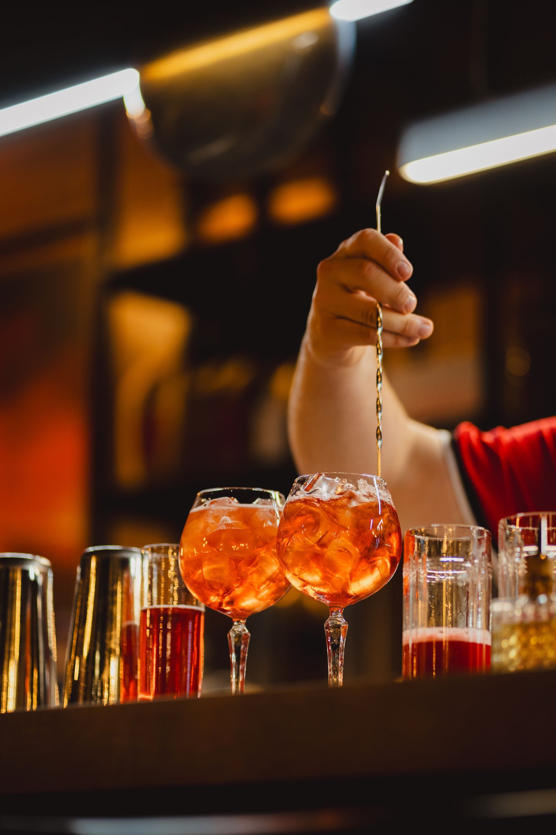 A Bartender is Pouring a Drink Into Two Glasses — Mumbo's Pizza'n'Pasta In Lismore, NSW
