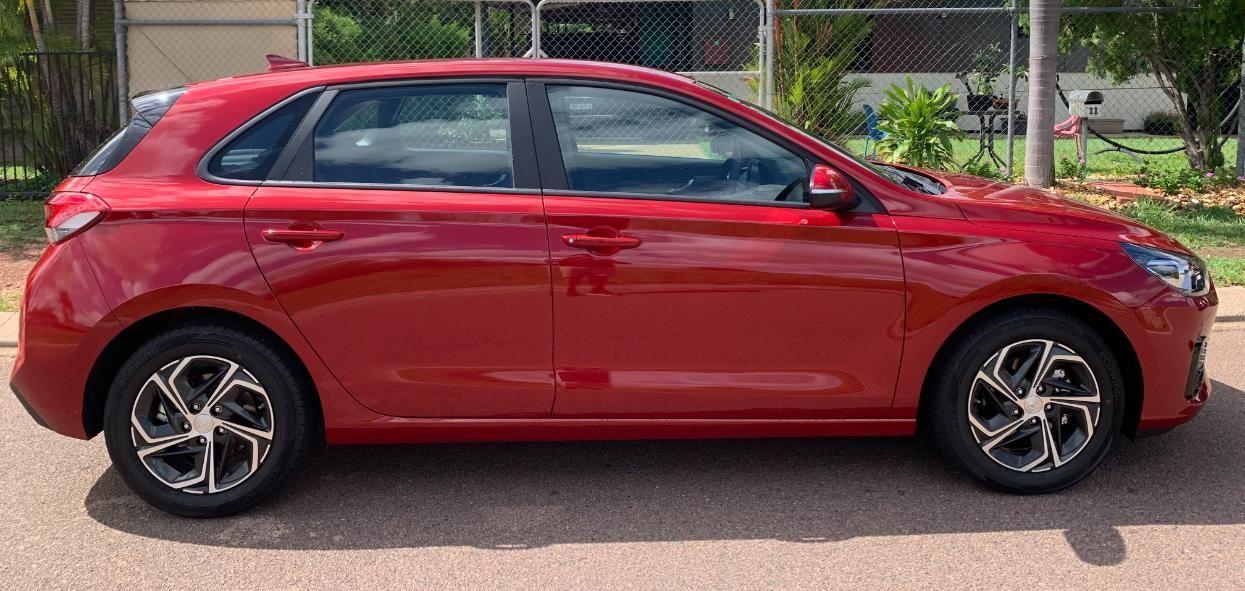 A Red Car Is Parked On The Road — Primera Driving School Darwin In Anula, NT