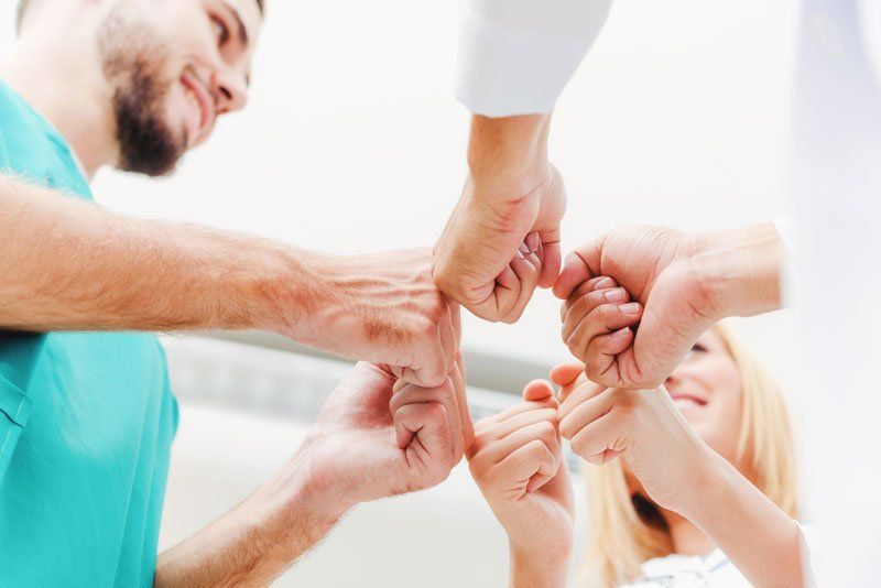Occupational Medicine Jobs — Medical Staff Join Hands Together in Baton Rouge, LA