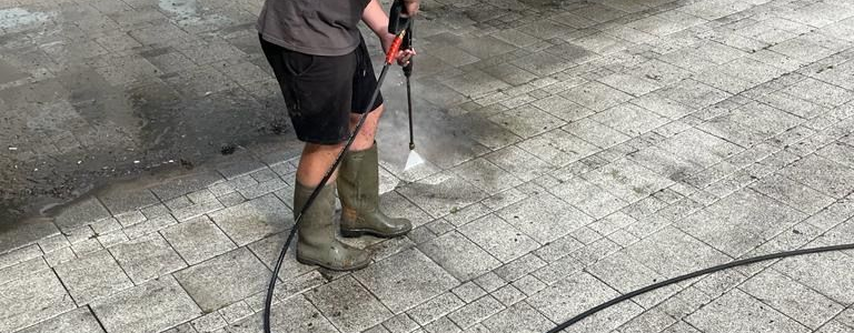 Astound Cleaning Group operative pressure washing a commercial forecourt with professional hot-wash system — commercial pressure washing Sussex & South London