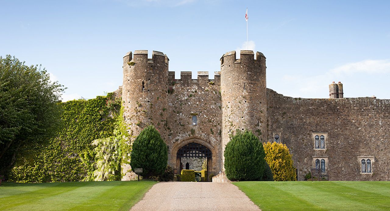 A large stone castle with a flag flying in front of it.