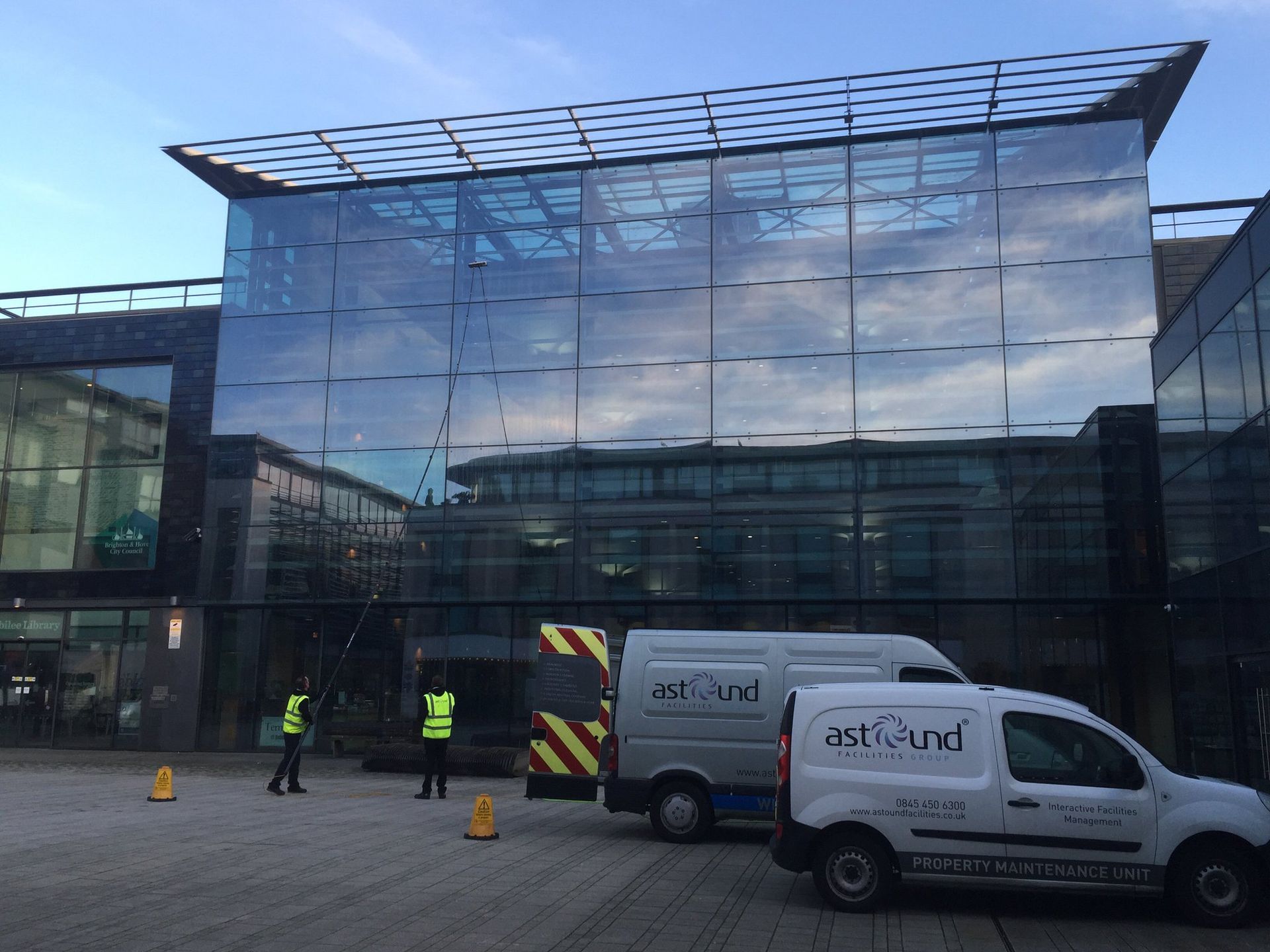 Two Man using telescopic pole with pure water doing commercial window cleaning brighton