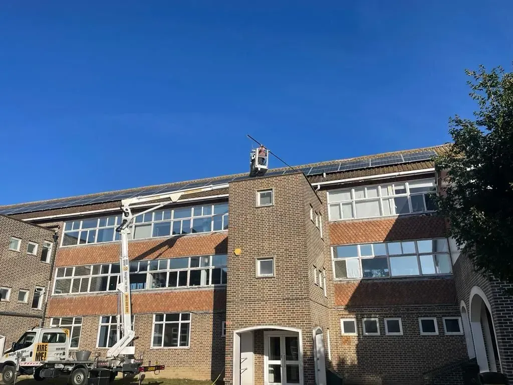 Boom lift with telescopic pole doing commercial window & solar cleaning on worthing building